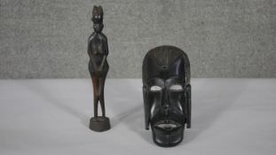 A 20th century carved tribal hardwood African mask and figure of a female. H.32 W.14cm (largest)