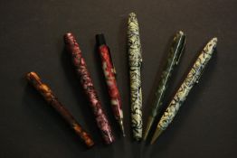 Six vintage pearlized plastic design ballpoint and fountain pens.