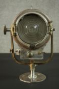 A vintage Mole-Richardson theatre spotlight and hinged wall bracket. Relief makers mark. H.20 Dia.