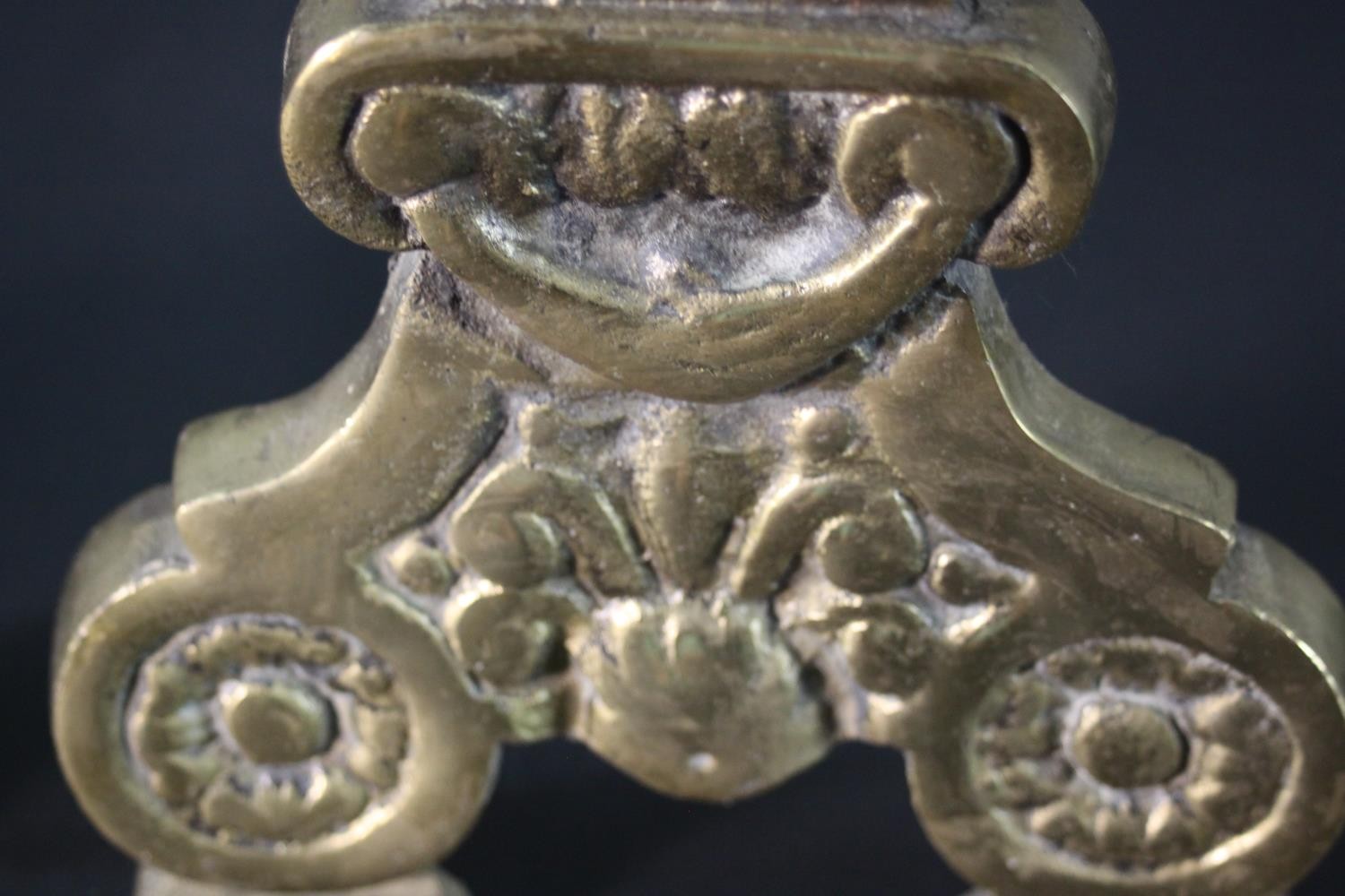 A pair of Victorian brass and cast iron fire dogs with floral motifs and turned finials. H.44 W. - Image 3 of 4