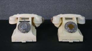 Two vintage cream bakelite telephones each with slide out trays and numbered to the base. One has