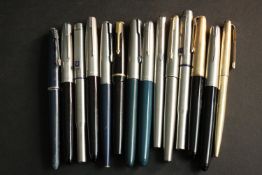A collection of fourteen vintage Parker fountain pens, various models and designs.