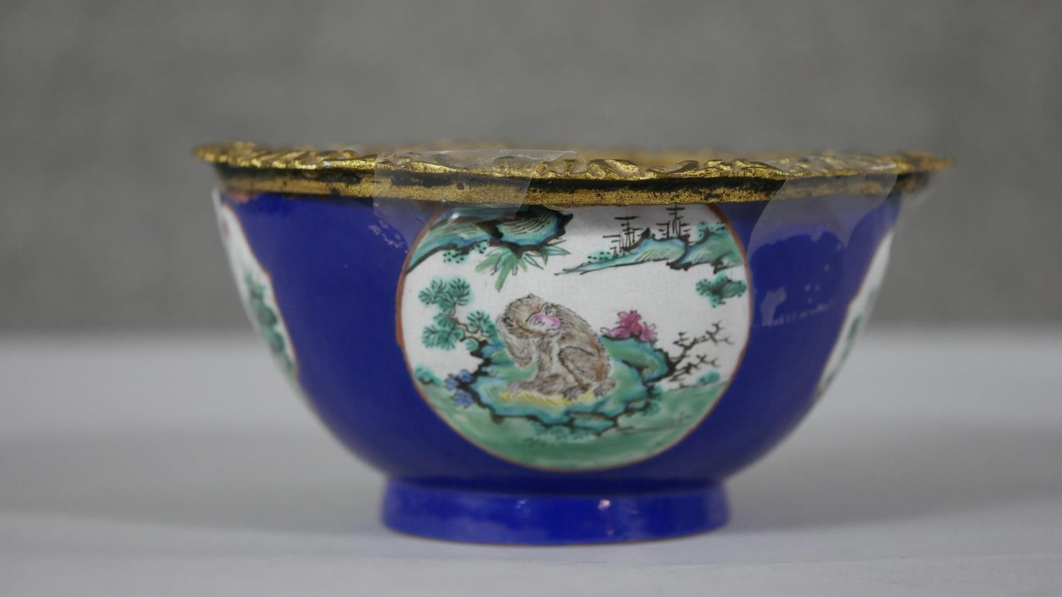 A Chinese hand painted ceramic bowl (used to be a vase) with added gilt ormolu edge. The bowl with a
