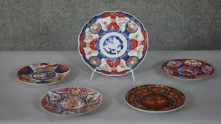 Five Japanese Imari style plates, one hand painted with four character mark to the base, the other