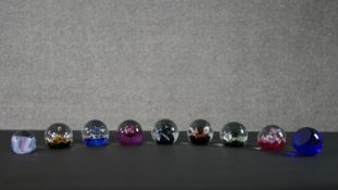 A collection of nine limited edition Caithness lamp work glass paperweights. Stamped to the base.