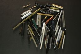 A Collection of fountain pen parts including barrels, pen nibs and lids. (8)