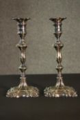 A pair of Victorian repousse design silver plated candlesticks, each with a stylised foliate design.