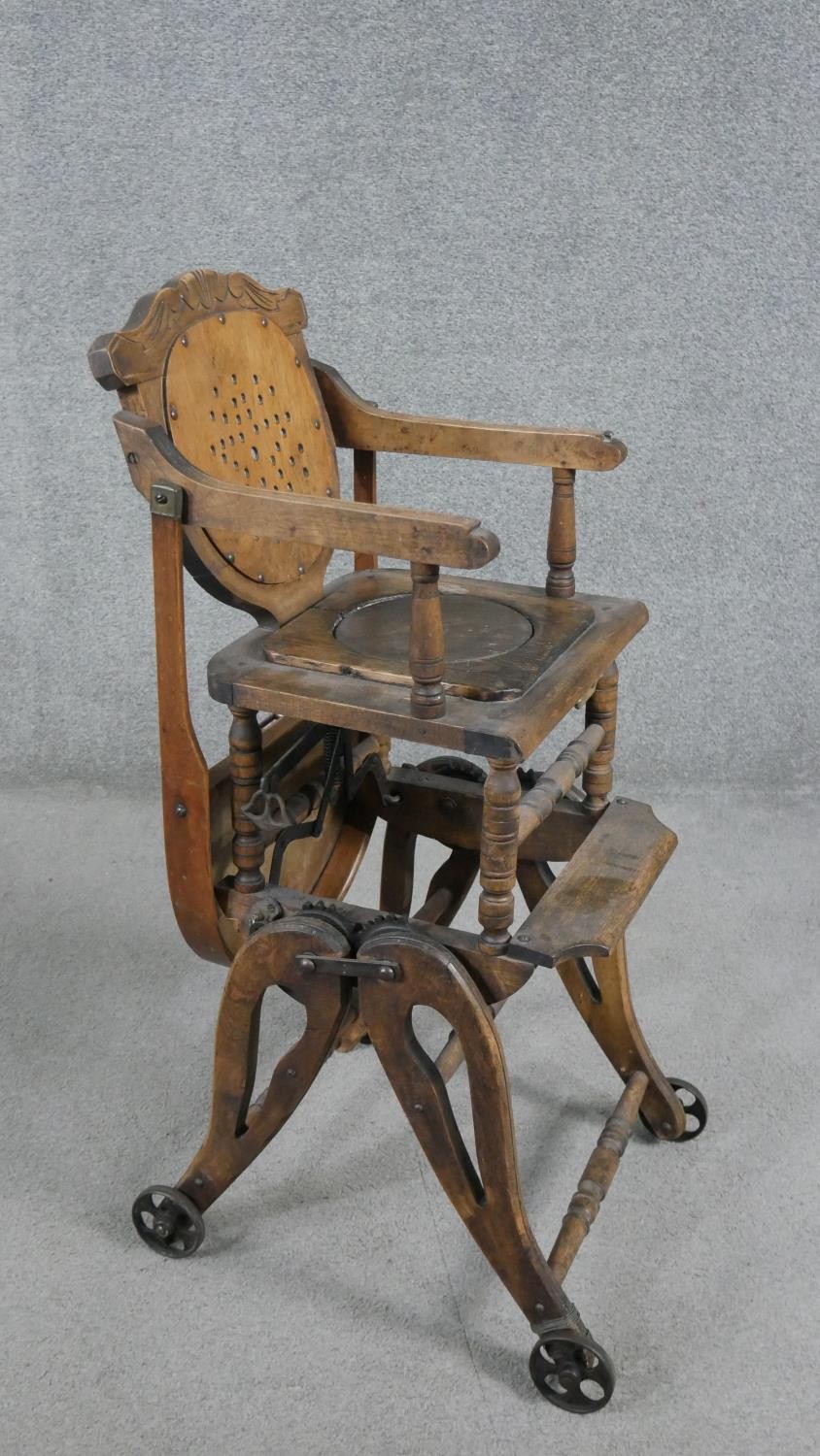 A late 19th century carved beech child's high chair converting to baby walker. H.87 W.39 D.61cm - Image 8 of 8