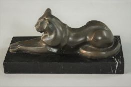 An Art Deco style bronze figure of a reclining panther, on a black marble base. Signed Milo. H.11