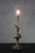 A large gilt spelter repousse design ewer table lamp mounted on a black and white marble base. H.