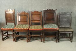 A collection of five early 18th century and earlier oak hall chairs with panel seats on