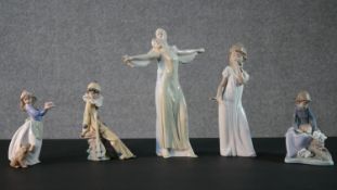 A collection of porcelain figures. Four Nao figures, a girl holding a cake with her dog , a clown, a