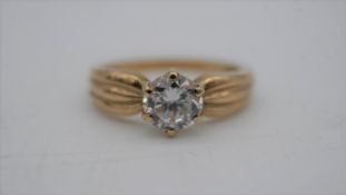A cubic zirconia and 9 carat gold solitaire ring. Set to centre with a round brilliant cut cubic