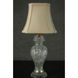 A vintage cut crystal vase design table lamp with etched floral design and cream silk shade. H.57cm