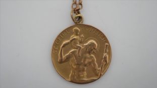 A 9ct gold St. Christopher medallion by Paul Vincze, on a 9ct gold trace chain with C-sprung