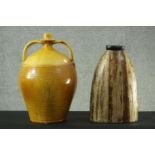 A large glazed twin handled stoneware flagon and a painted hardwood vase. H.42 Dia.25 cm.