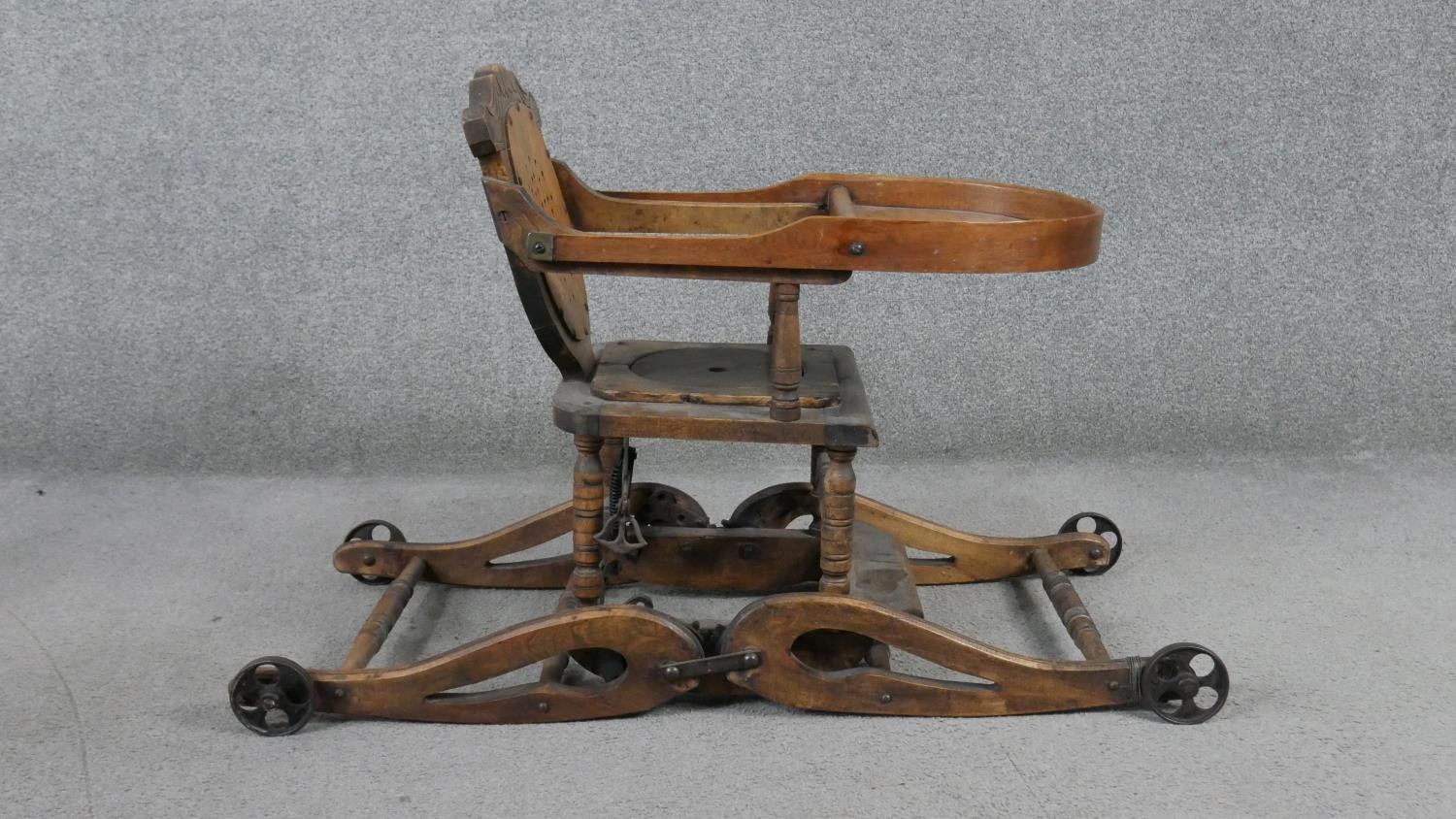 A late 19th century carved beech child's high chair converting to baby walker. H.87 W.39 D.61cm - Image 4 of 8