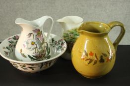 A Victorian style jug and bowl set along with two jugs. H.23 W.24 D.17 cm.