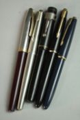 A collection of five 14 carat gold-nibbed vintage fountain pens, including a vintage Sheaffer PFM