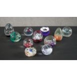 A collection of eleven lamp work paperweights by various makers, including CG, Mdina glass and