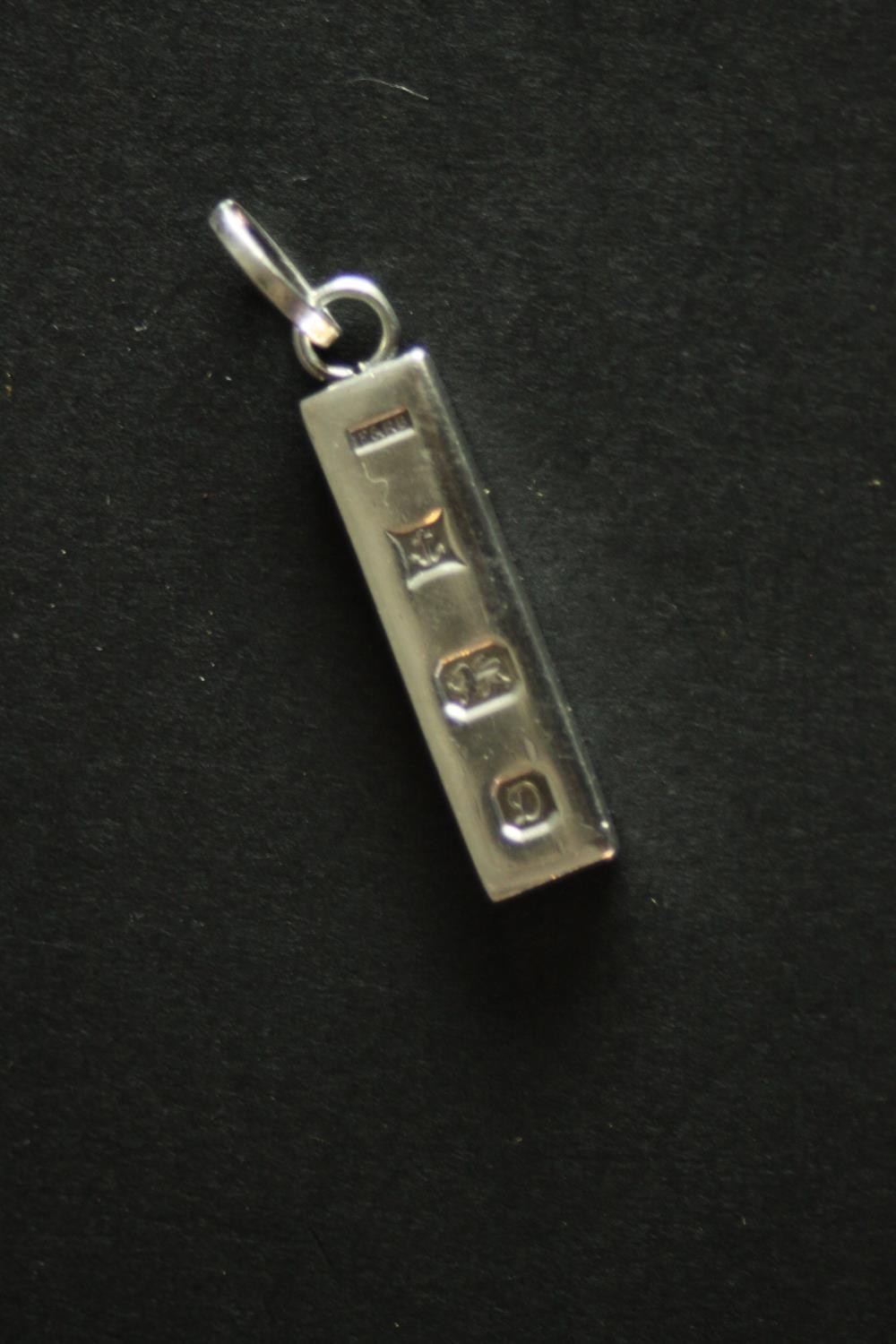 Three silver ingot pendants, each stamped to the front with a different set of hallmarks. Makers: - Image 7 of 10