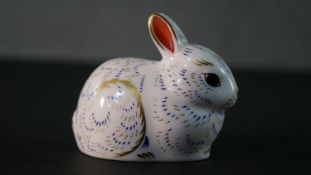 A Royal Crown Derby paperweight rabbit with gold stopper. H.7.5 W.8 D.4cm