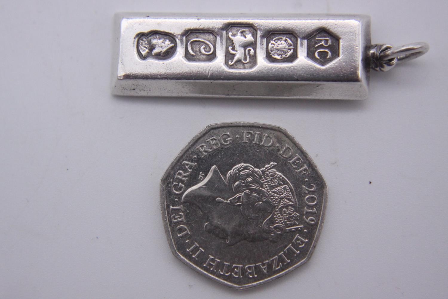 Three silver ingot pendants, each stamped to the front with a different set of hallmarks. Makers: - Image 10 of 10