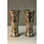 A pair of engraved silver plated trumpet vases. decorated with scrolling design and floral motifs.
