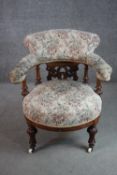 A Victorian walnut armchair, upholstered in a tapestry fabric, with a pierced splat back, on lobed