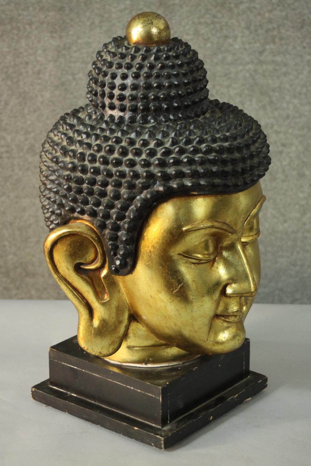 A 20th century gilded carved wooden Buddha head on a pedestal base. H.55 W.30cm. - Image 2 of 6