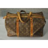 A small Louis Vuitton monogrammed canvas keep all bag with brass hardware. H.23 W.38cm