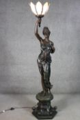 A very large bronze effect resin Greek goddess form floor lamp on foliate design column base with