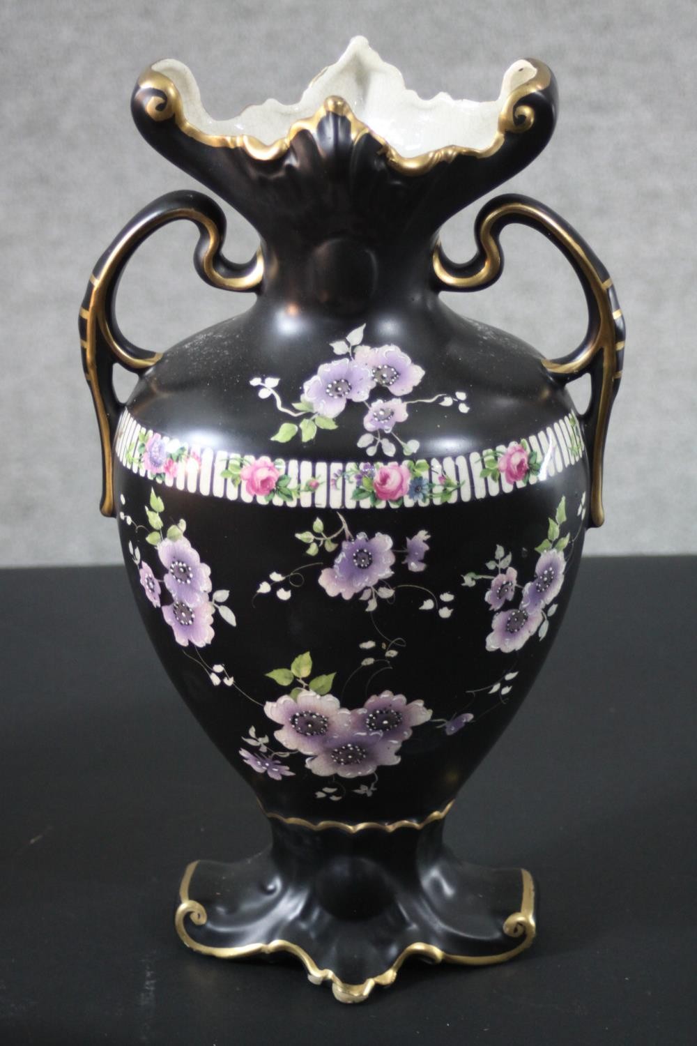 A pair of Victorian black glaze flower design twin handled vases with gilded rims along with a - Image 3 of 7