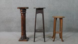 A carved hardwood jardiniere stand of columnar form, together with two oak jardiniere stands, each