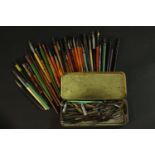 A large collection of vintage dip pens and a vintage tin of calligraphy nibs. Various makers and