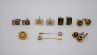 A collections of gold plated cufflinks, tie pins and a pin badge. The cufflinks include a pair of