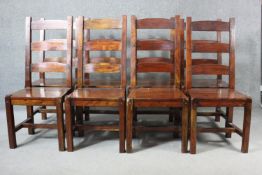 A set of eight mango wood ladder back dining chairs, the legs joined by H stretchers.