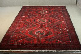 A red ground handmade Persian Lorestan carpet. L.256 W.175cm.