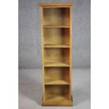 A pine bookshelf, of narrow proportions, on a plinth base. H.116 W.36 D.18cm.