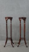 A pair of hardwood jardiniere stands, the circular top on turned columns, joined by an undertier, on