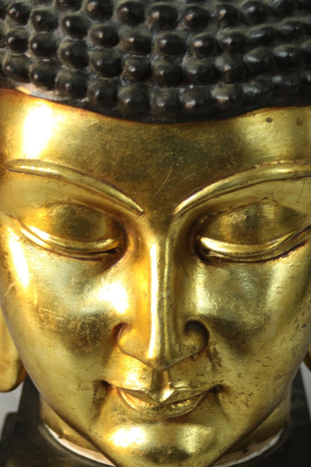 A 20th century gilded carved wooden Buddha head on a pedestal base. H.55 W.30cm. - Image 4 of 6