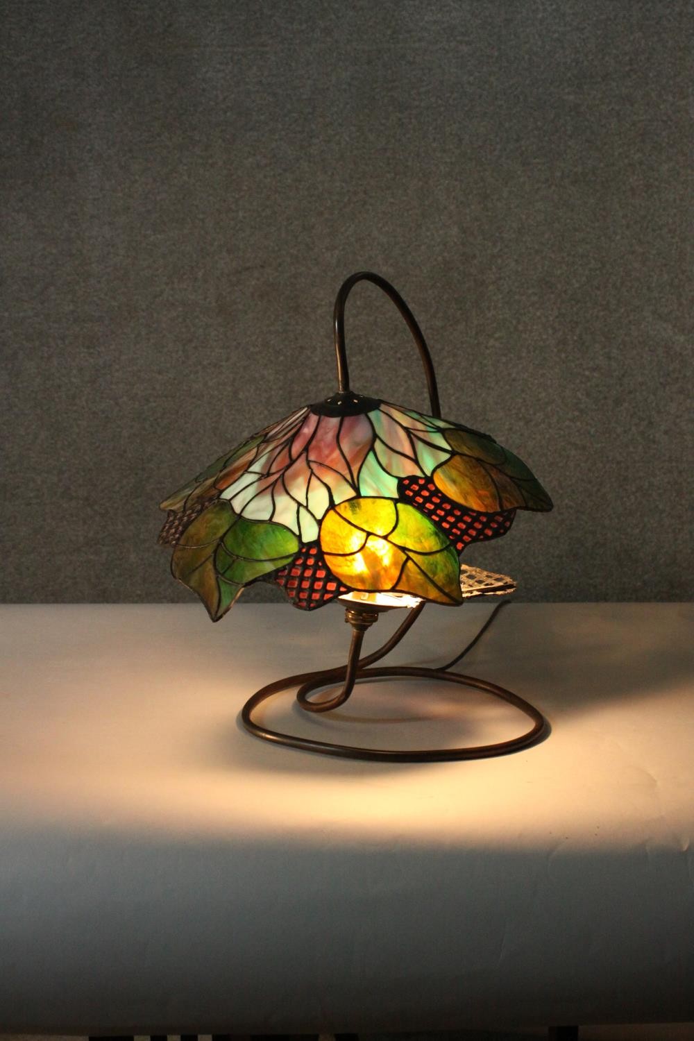 A Tiffany style stained glass table lamp, the shade with foliate design. H.48 W.40cm. - Image 6 of 8