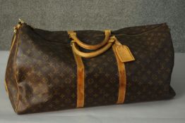 A Louis Vuitton "Keepall" 60, date code: , Monogram canvas exterior with leather trim, dual rolled