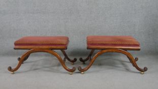 A pair of William IV mahogany footstools, with rectangular upholstered seats, on undulating supports