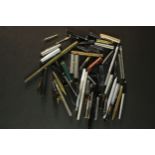 A Collection of fountain pen parts including barrels, pen nibs and lids. (8)