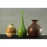A large turned hardwood baluster vase along with a stoneware jug with incised decoration and a green