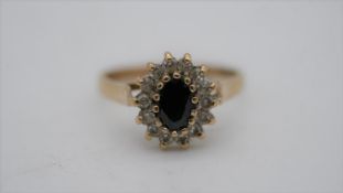 A black stone and cubic zirconia vintage cluster ring. Set to centre with an oval mixed cut black