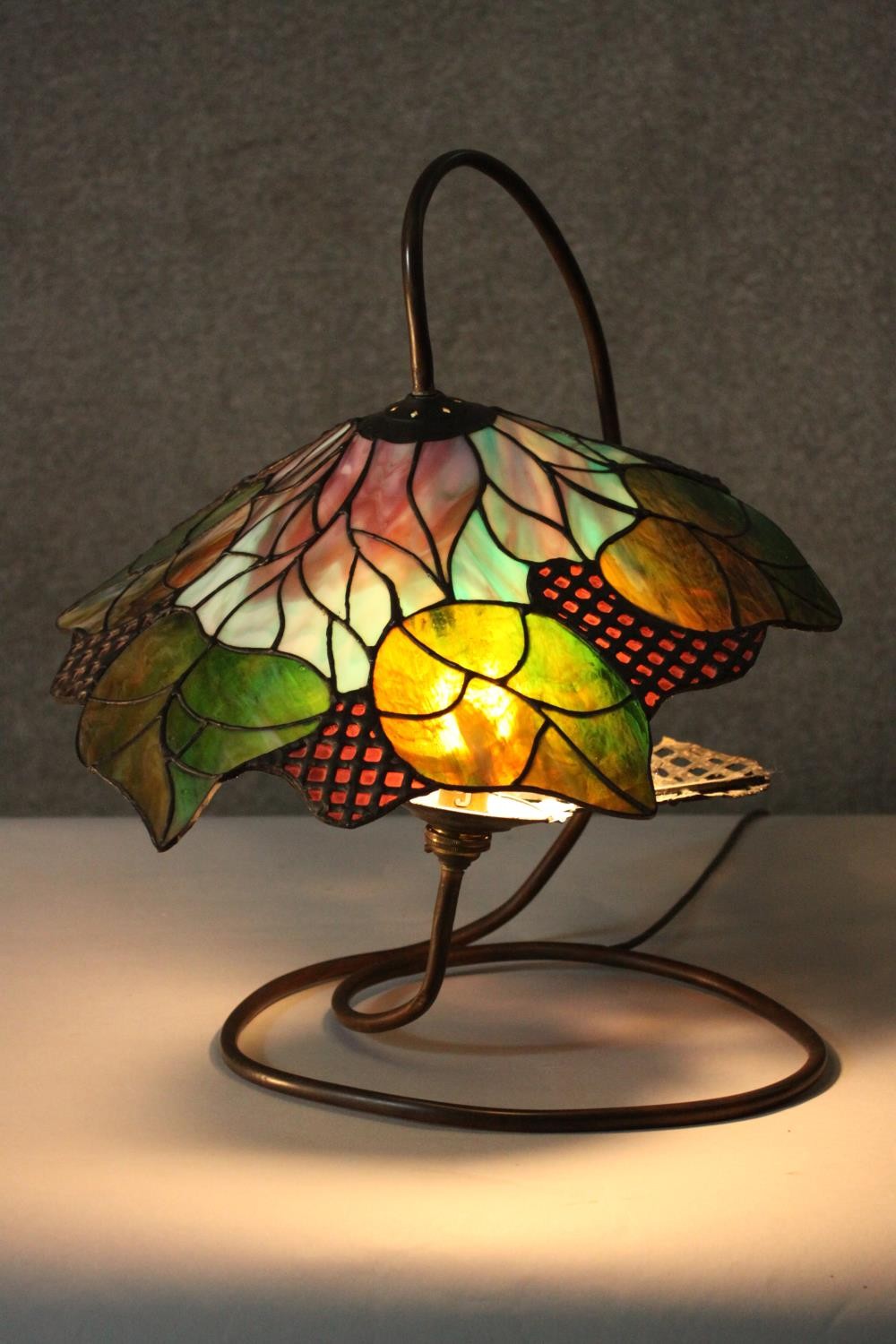 A Tiffany style stained glass table lamp, the shade with foliate design. H.48 W.40cm. - Image 7 of 8