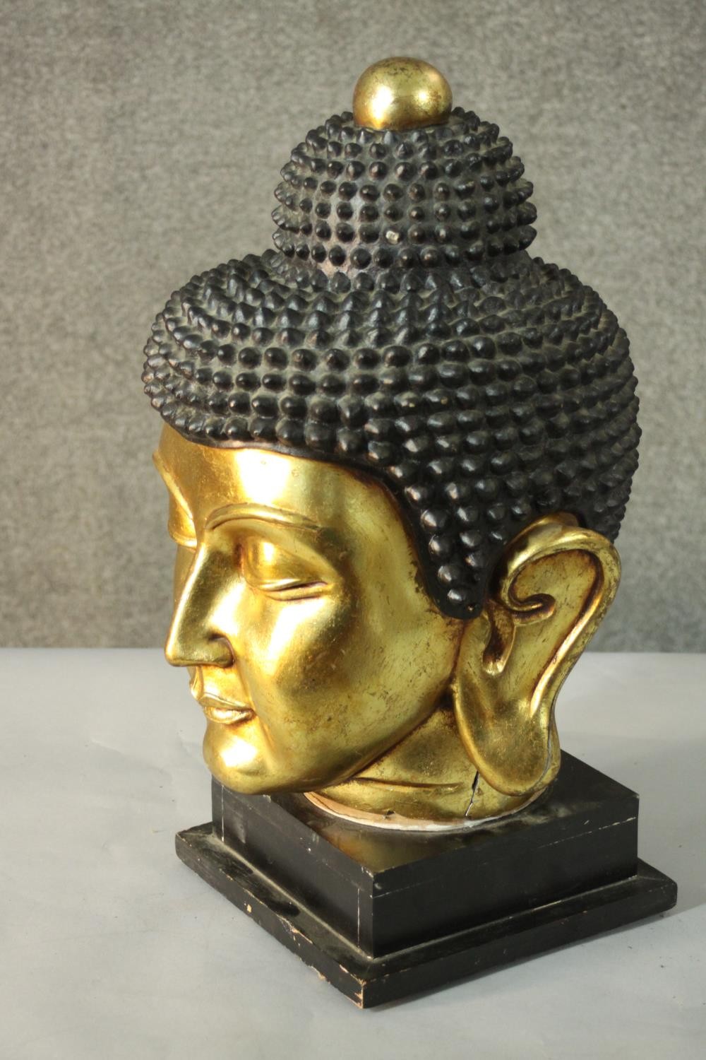 A 20th century gilded carved wooden Buddha head on a pedestal base. H.55 W.30cm. - Image 3 of 6