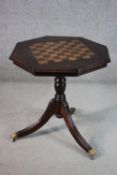 A George III style mahogany chess table, the octagonal top inlaid with a chessboard, on tripod